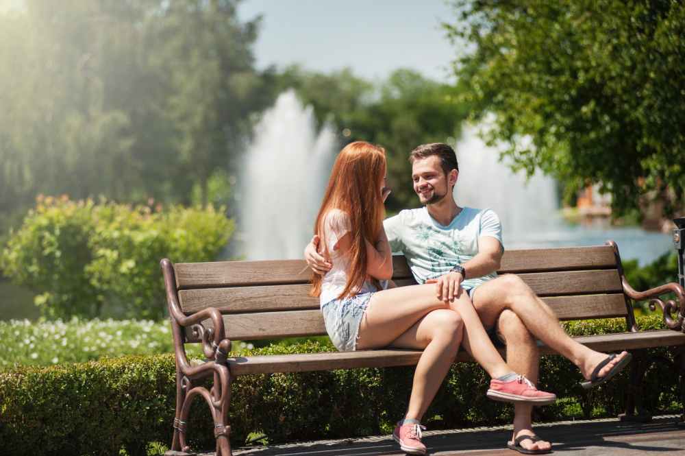 man and woman sitting on a bench